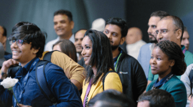 Attendees smiling at a conference